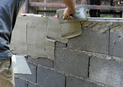 cement brick wall being constructed